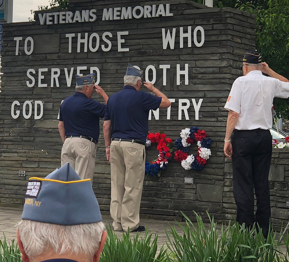 Members of the American Legion along with other groups present approached the memorial, placed a wreath and saluted.